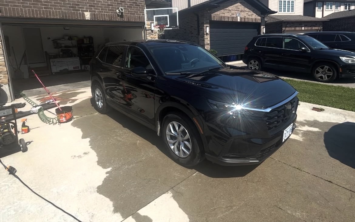 Professional mobile detailing of a black SUV in a residential driveway